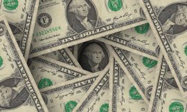 Dollar Gains and Gold Falls on Hawkish Fed Comments